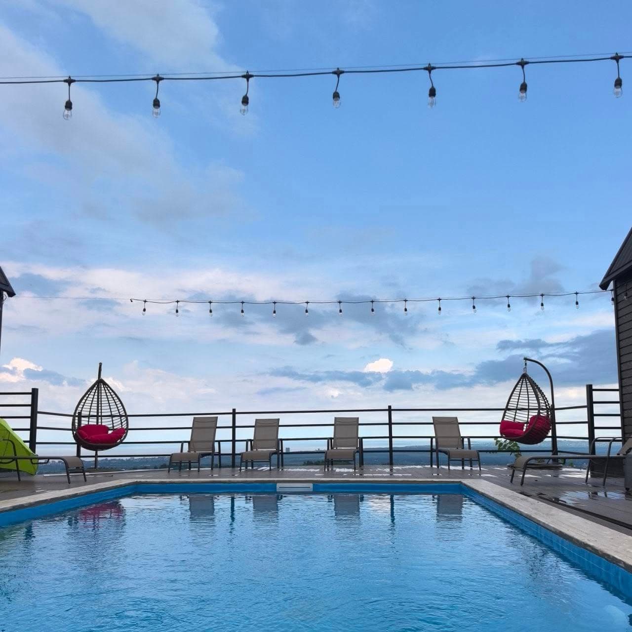 Pool deck with sun loungers and Black Sea view